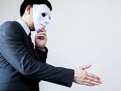 man hiding behind a mask