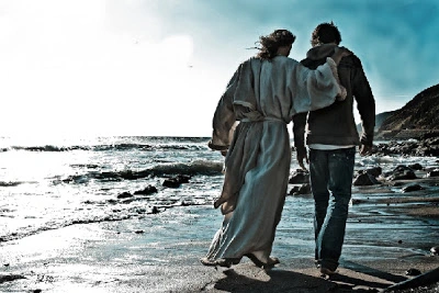 Jesus walking with a man on the beach